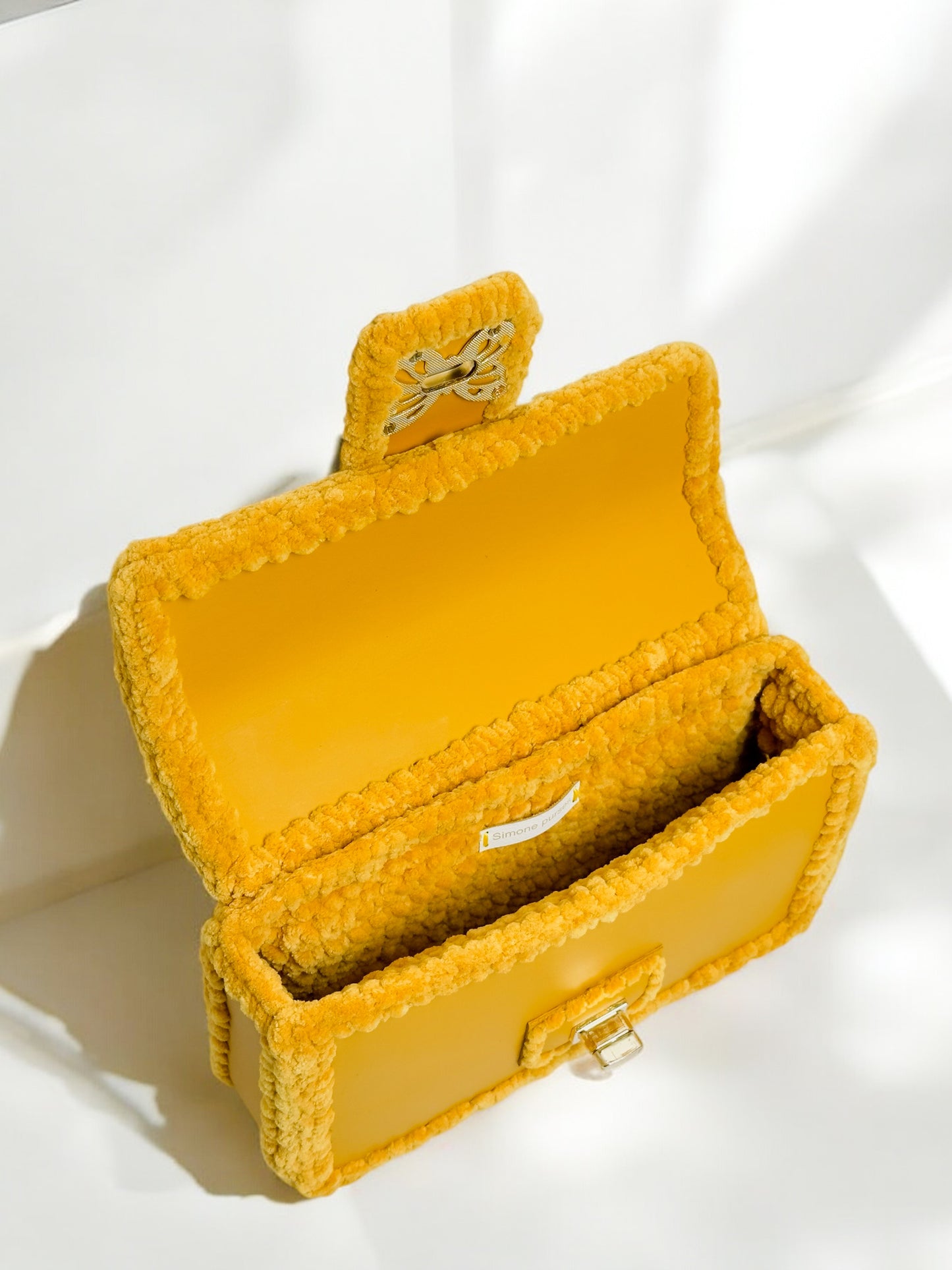 Gold-yellow ladies handbag with gold butterfly clasp