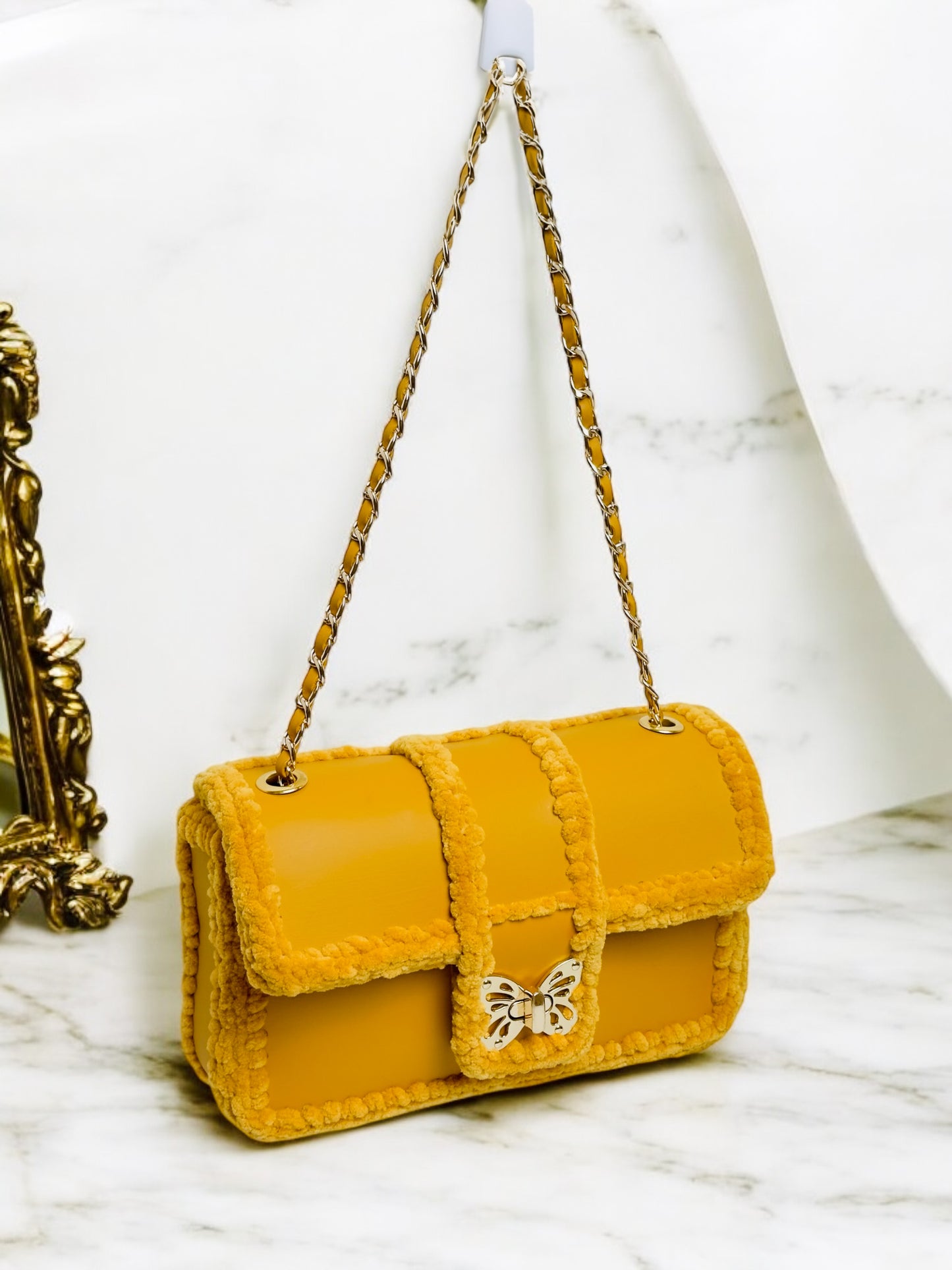 Gold-yellow ladies handbag with gold butterfly clasp