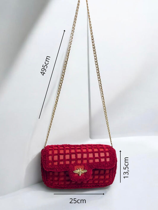 red mesh handbag with gold chain and bee ornament