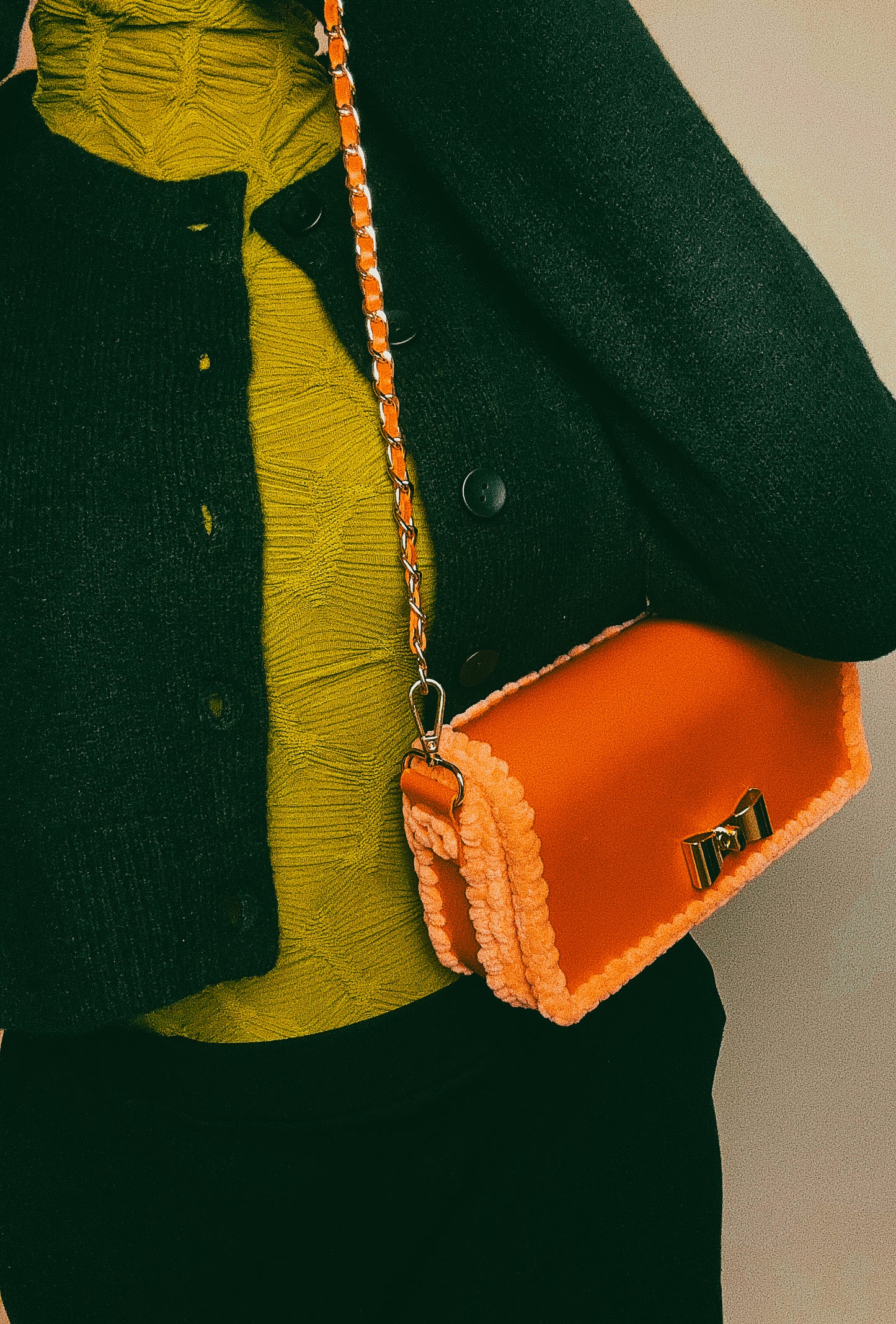 Orange metallic handbag with gold chain