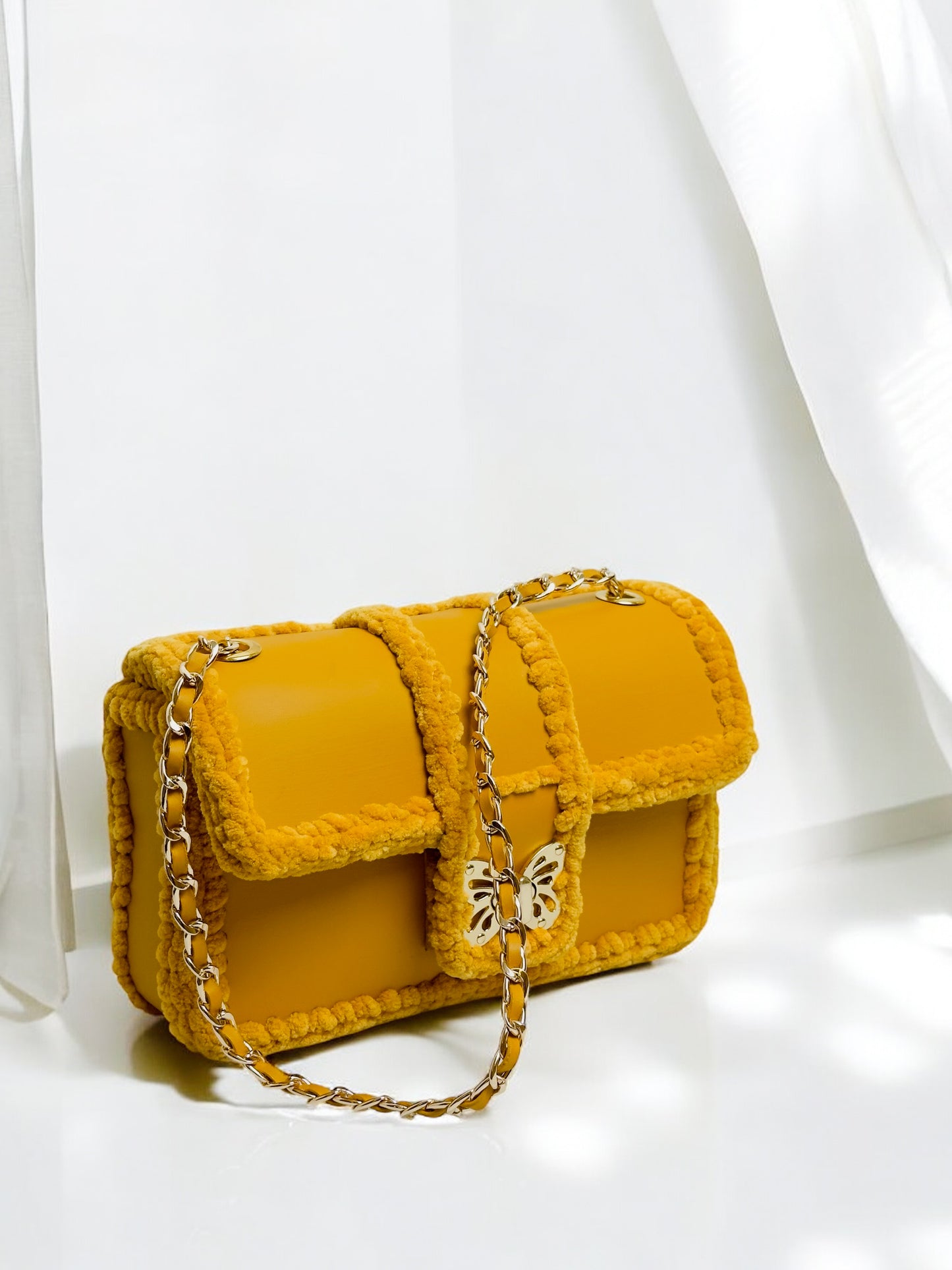 Gold-yellow ladies handbag with gold butterfly clasp