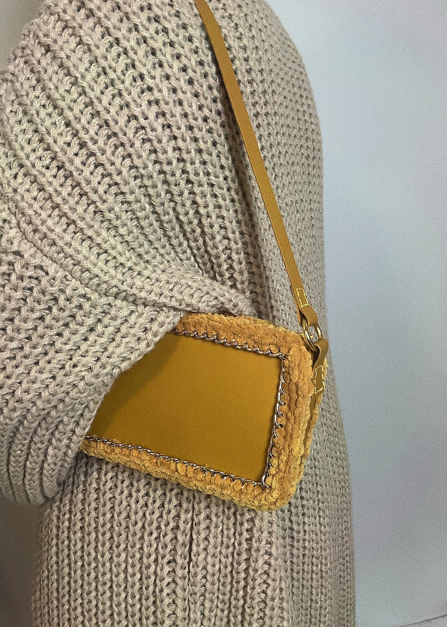 Yellow handbag with golden chain and braided wool borders