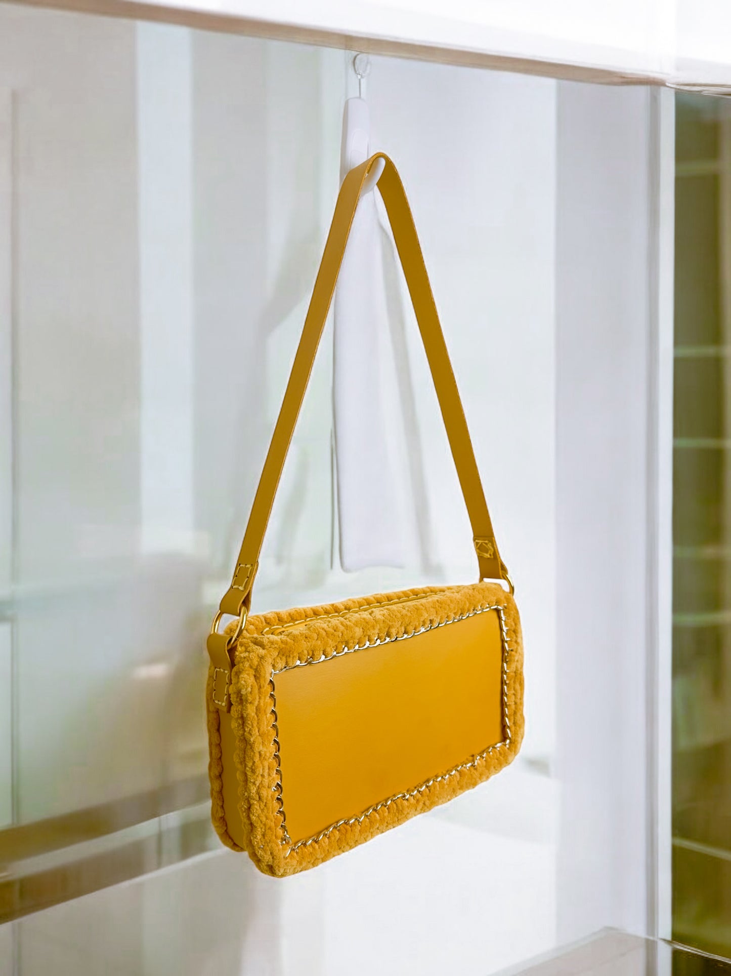 Yellow handbag with golden chain and braided wool borders