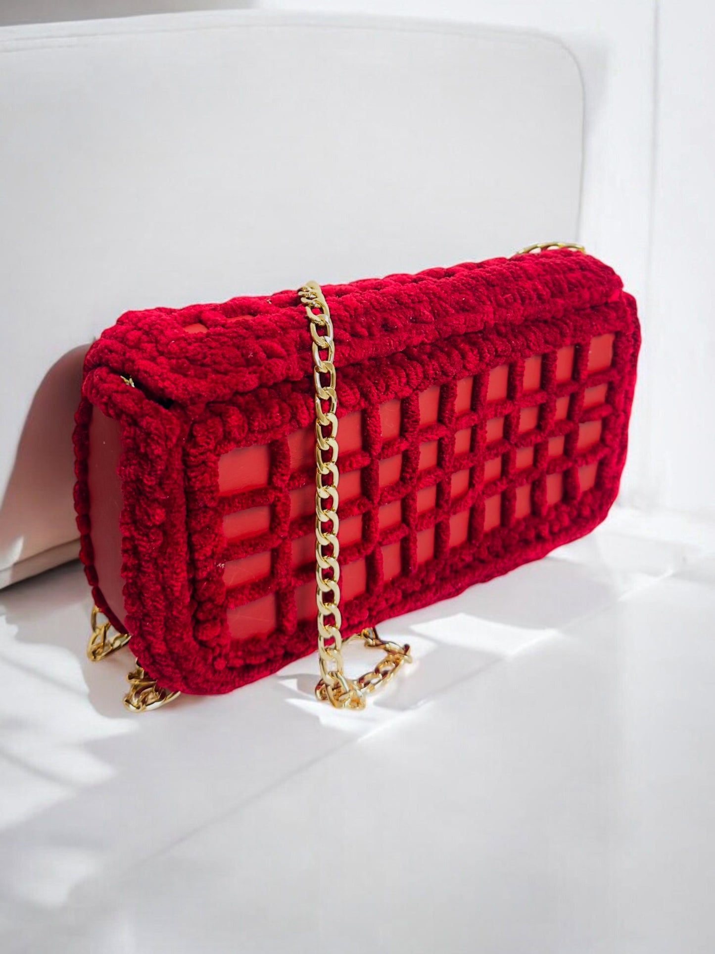 red mesh handbag with gold chain and bee ornament