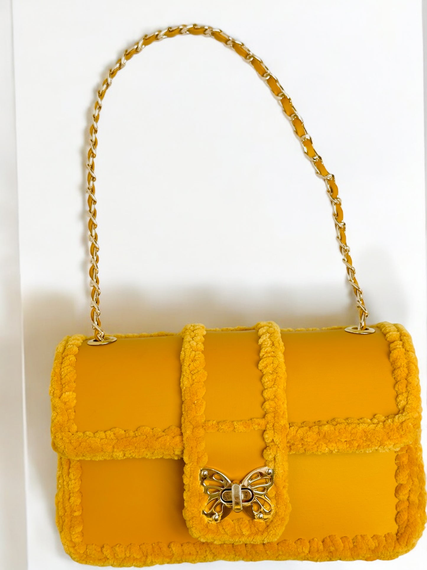 Gold-yellow ladies handbag with gold butterfly clasp