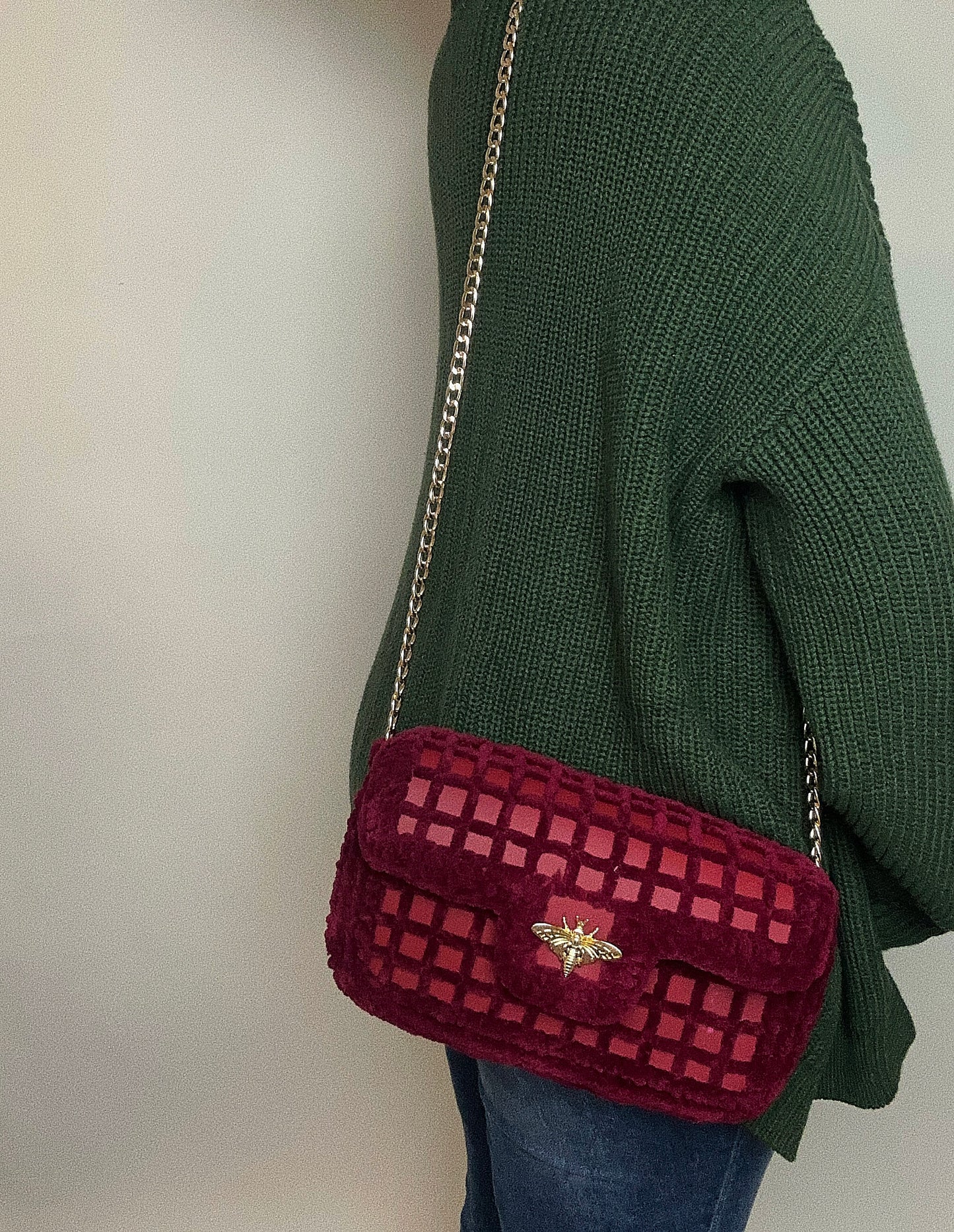 red mesh handbag with gold chain and bee ornament