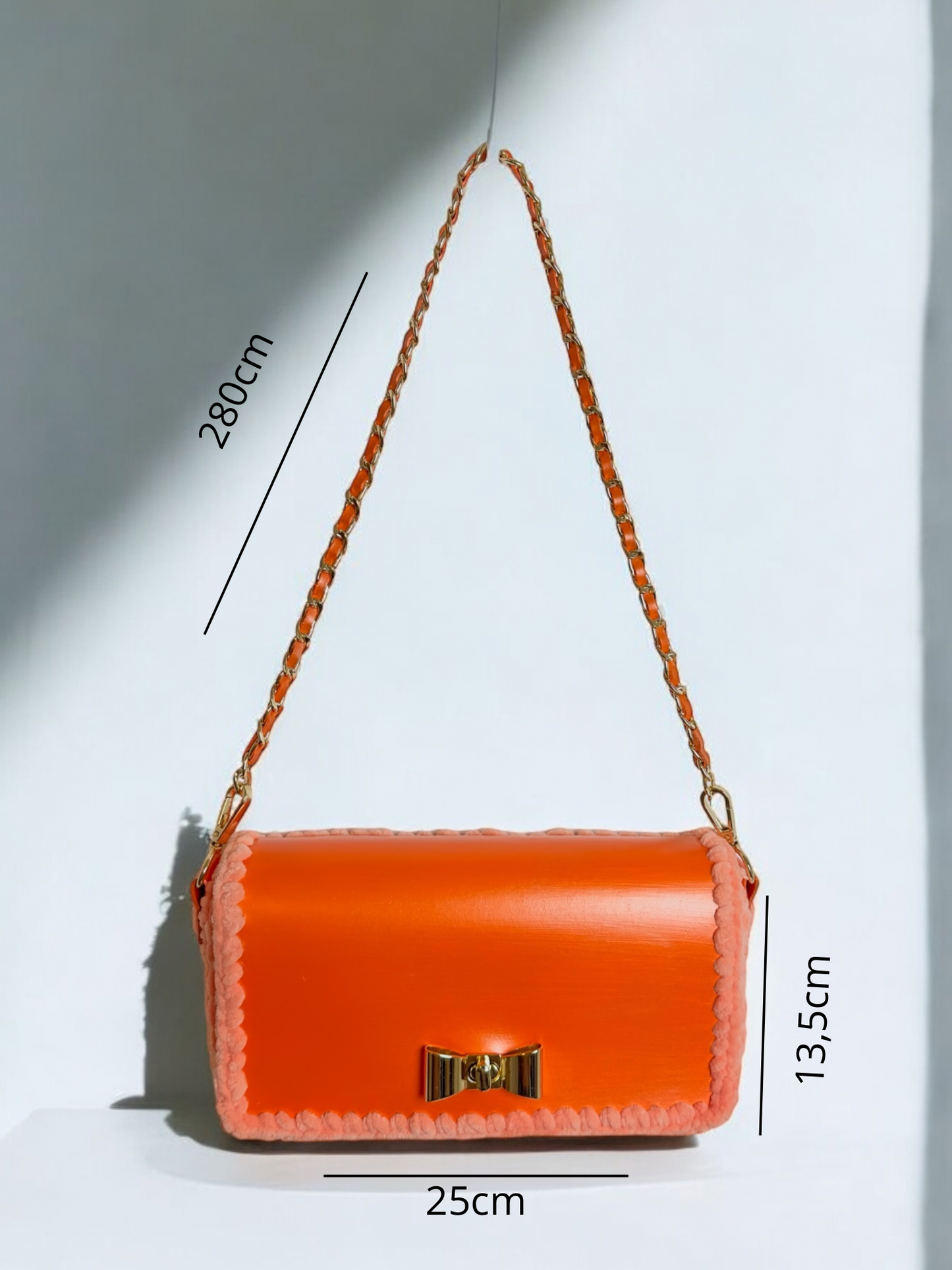 Orange metallic handbag with gold chain